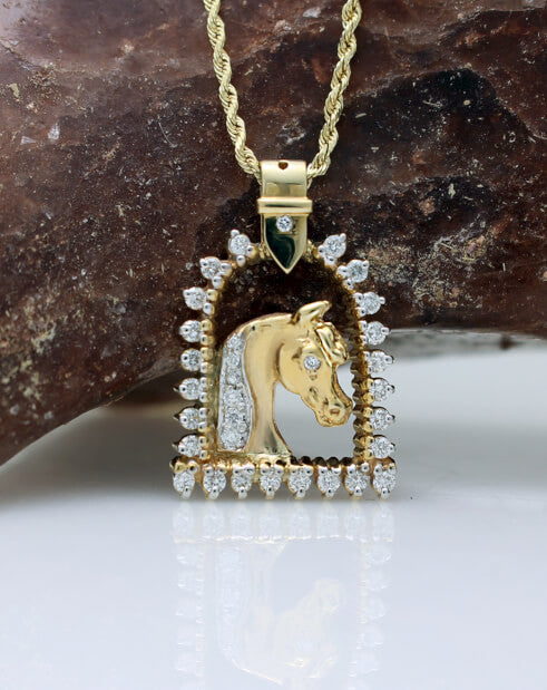 Gold and diamond horse and stirrup pendant copyrighted design is handcrafted by Lesley Rand Bennett