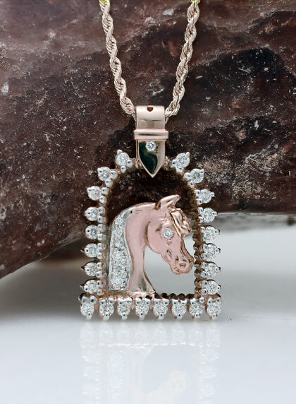 Rose gold and diamond horse and stirrup pendant copyrighted design is handcrafted by Lesley Rand Bennett